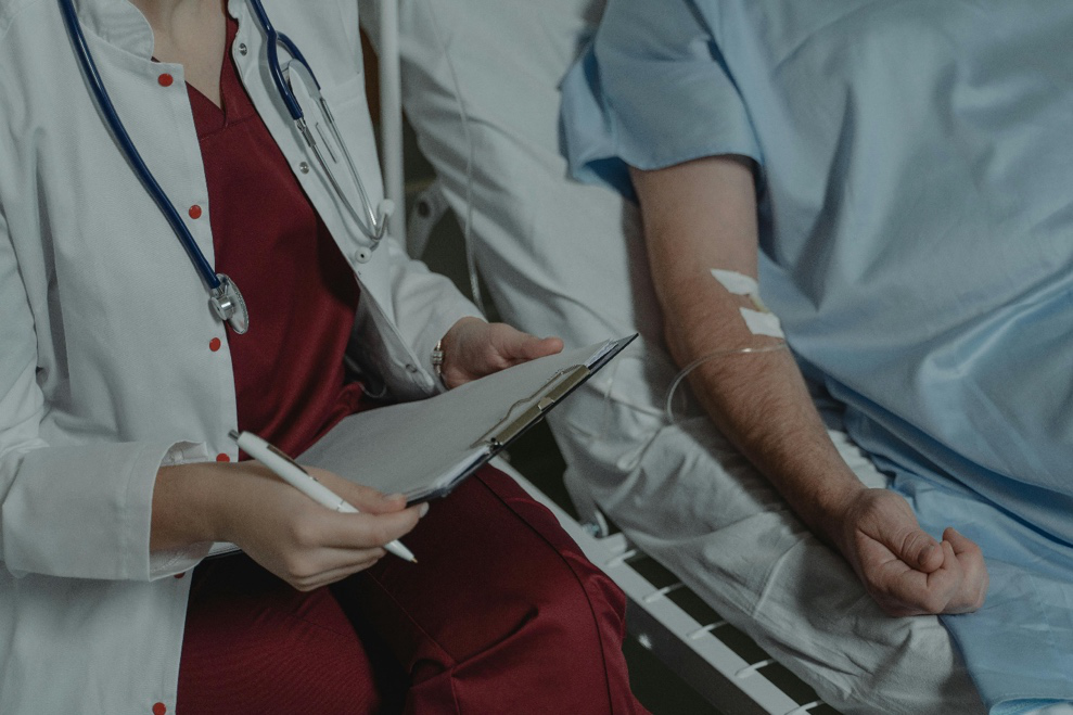 Patient receiving care from a doctor at a hospital bed