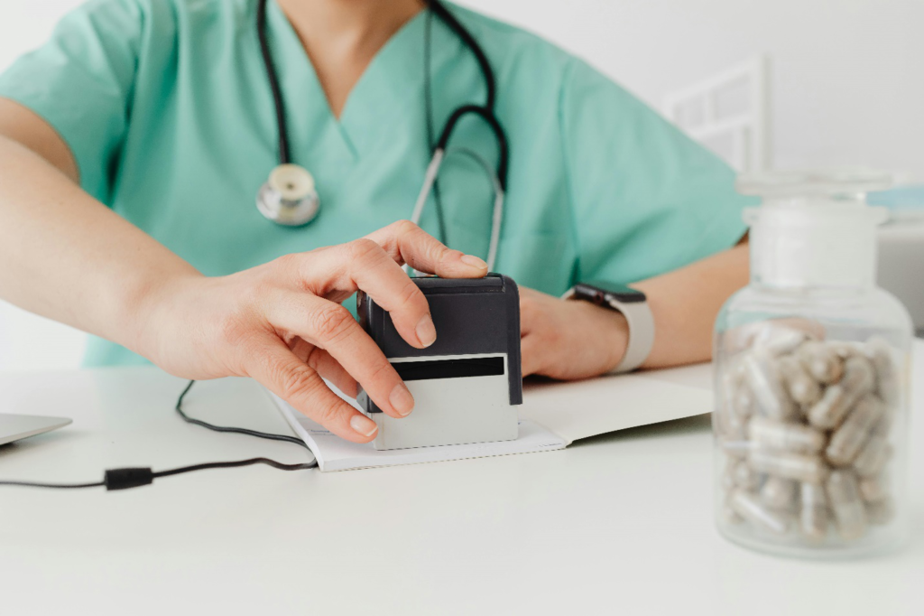 Doctor stamping papers