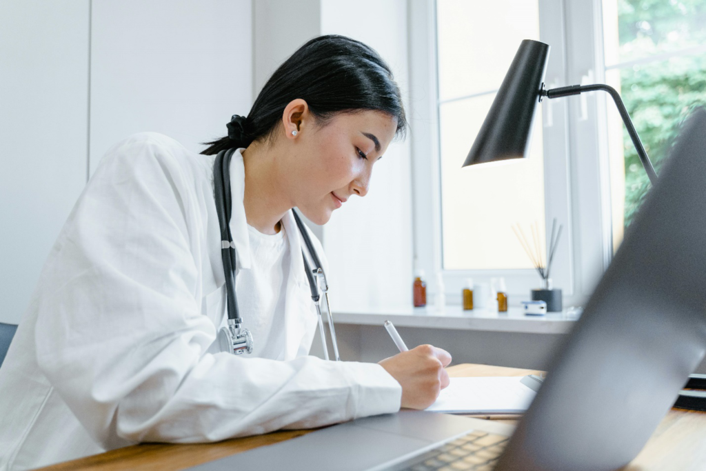 Doctor writing on a notepad