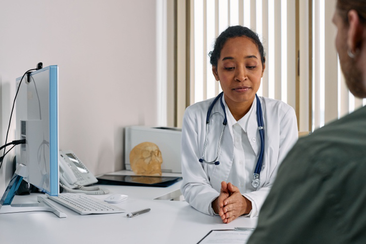 Specialist discussing colorectal cancer treatment options with a patient during a consultation.