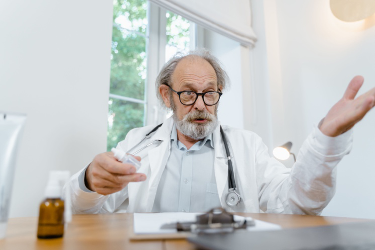 Gastroenterologist explaining colonoscopy screening and early detection options to a patient.