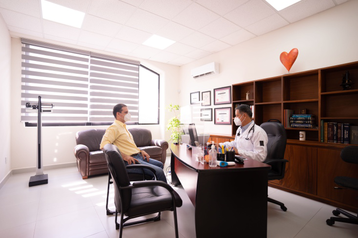 Doctor discussing colon cancer prevention strategies and screening recommendations with an adult patient over 45.