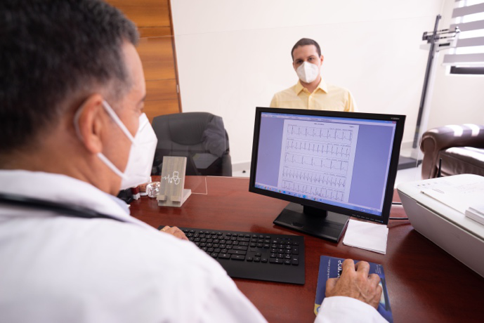 Gastroenterologist reviewing liver test results with a patient during a hepatology consultation.