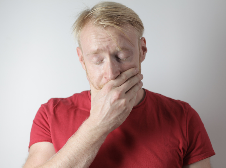 Stressed person covering mouth